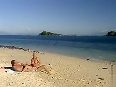 Blonde bimbo makes a hot manual stimulation at the beach