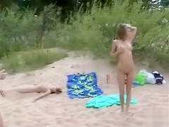 Russian nudist teens play in the sand