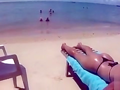 Desirable dish lets her man put sunscreen on her slim body