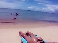 Desirable dish lets her man put sunscreen on her slim body