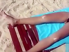 Desirable dish lets her man put sunscreen on her slim body