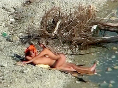 Lazy guy cums into a girlfriend's pussy on the nudist beach