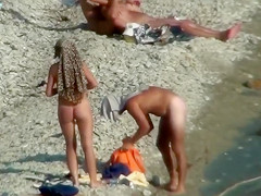 Lazy guy cums into a girlfriend's pussy on the nudist beach