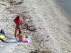 Sensual girl jumps on her boyfriend's fat dick at the nude beach