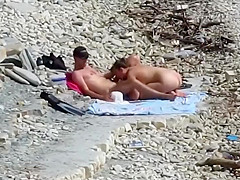 Sensual girl jumps on her boyfriend's fat dick at the nude beach