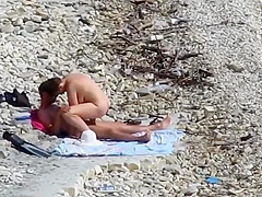 Sensual girl jumps on her boyfriend's fat dick at the nude beach