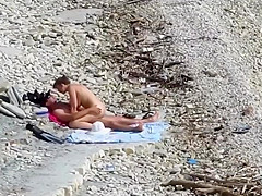 Sensual girl jumps on her boyfriend's fat dick at the nude beach