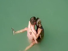 Adorable woman has steaming hot sex in the water