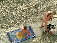 Spying guy catches a couple copulating at the beach