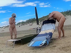 Older people walk around the beach completely naked