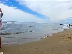 Older people walk around the beach completely naked
