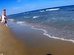 Older people walk around the beach completely naked