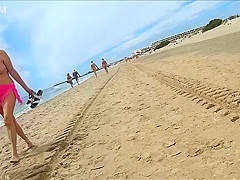 Older people walk around the beach completely naked