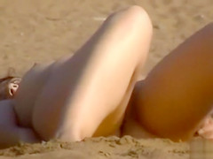 Cute brunette loves to pose on the beach