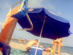 Ravishing woman strips out of a tight red dress in the sun