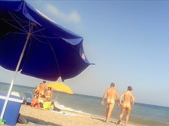 Ravishing woman strips out of a tight red dress in the sun