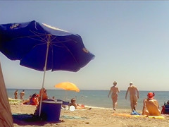 Ravishing woman strips out of a tight red dress in the sun