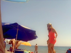 Ravishing woman strips out of a tight red dress in the sun