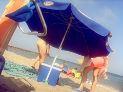 Ravishing woman strips out of a tight red dress in the sun