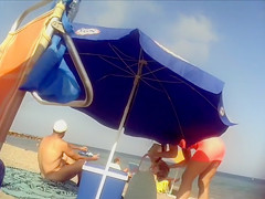 Ravishing woman strips out of a tight red dress in the sun