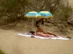 Hubby playing with her pussy in beach voyeur view