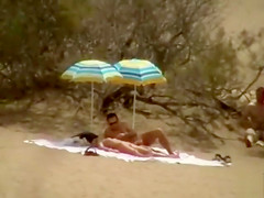 Hubby playing with her pussy in beach voyeur view