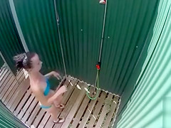 Skinny brunette filly takes a quick shower in the beach cabin