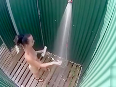 Skinny brunette filly takes a quick shower in the beach cabin