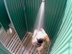 Skinny brunette filly takes a quick shower in the beach cabin