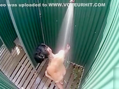 Skinny brunette filly takes a quick shower in the beach cabin