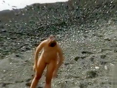 Small tits girl is naked and sexy on the beach
