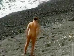 Small tits girl is naked and sexy on the beach