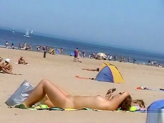Sunny day at the public beach with two nudist girls