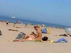 Sunny day at the public beach with two nudist girls