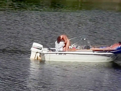 Nudist couple has fun in the middle of a beautiful lake