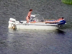 Nudist couple has fun in the middle of a beautiful lake