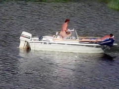 Nudist couple has fun in the middle of a beautiful lake