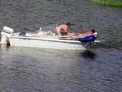 Nudist couple has fun in the middle of a beautiful lake