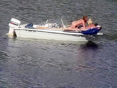 Nudist couple has fun in the middle of a beautiful lake
