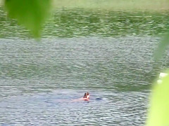 Nudist couple has fun in the middle of a beautiful lake