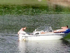 Nudist couple has fun in the middle of a beautiful lake