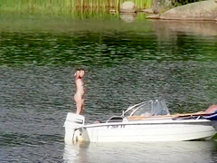 Nudist couple has fun in the middle of a beautiful lake