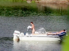 Nudist couple has fun in the middle of a beautiful lake