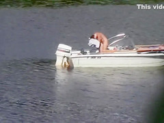 Nudist couple has fun in the middle of a beautiful lake