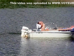 Nudist couple has fun in the middle of a beautiful lake