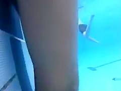 Playgirl tugs on a friend's dick in the pool