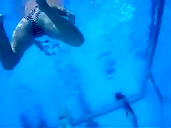 Playgirl tugs on a friend's dick in the pool