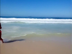 Large-assed harlot wears a flimsy bikini to the beach