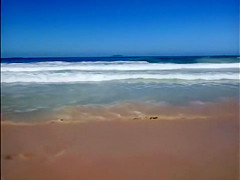 Large-assed harlot wears a flimsy bikini to the beach