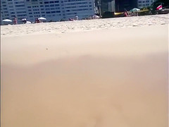 Large-assed harlot wears a flimsy bikini to the beach